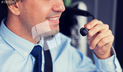 Image of close up of happy bus driver talking to microphone