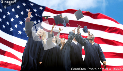 Image of happy students throwing mortarboards up