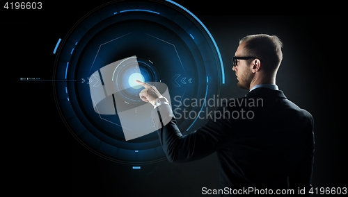 Image of businessman pointing finger to virtual projection