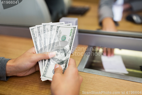 Image of hands with money at bank office or exchanger