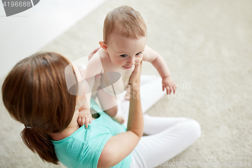 Image of happy young mother with little baby at home