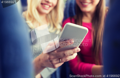 Image of close up of women in travel bus with smartphone