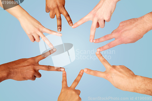 Image of group of international people showing peace sign