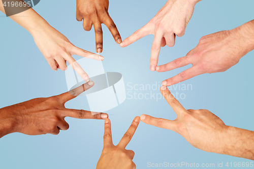 Image of group of international people showing peace sign
