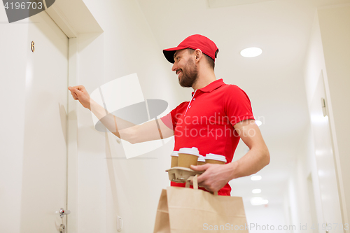 Image of delivery man with coffee and food knocking on door