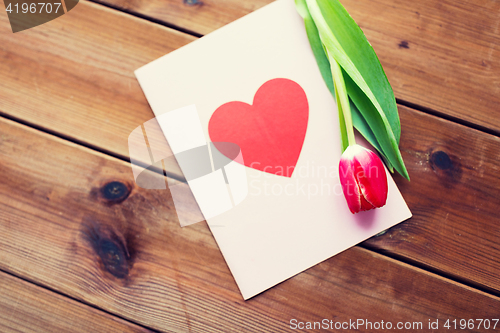 Image of close up of flowers and greeting card with heart