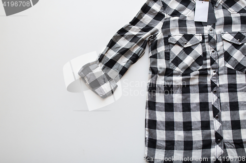 Image of close up of checkered shirt on white background