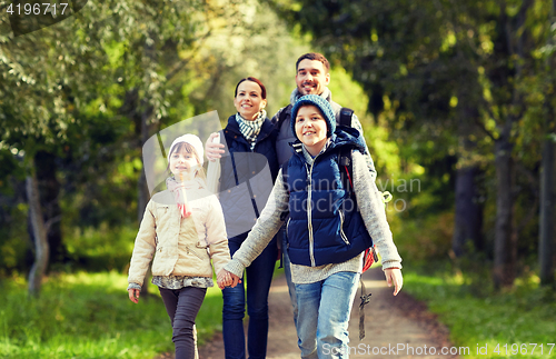 Image of happy family with backpacks hiking