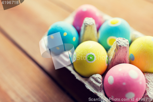 Image of close up of colored easter eggs in egg box