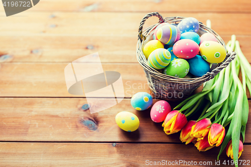 Image of close up of easter eggs in basket and flowers