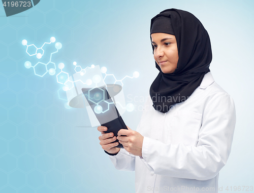 Image of muslim female with tablet pc and chemical formula