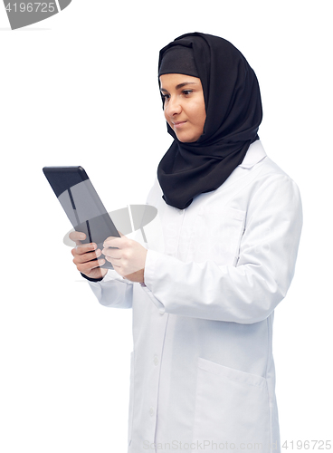 Image of muslim female doctor in hijab with tablet pc