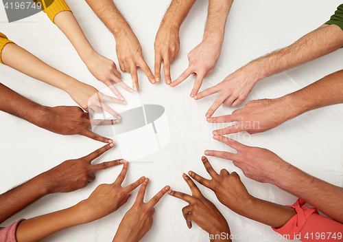 Image of group of international people showing peace sign