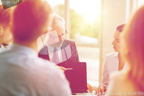 Image of business people with laptop meeting in office