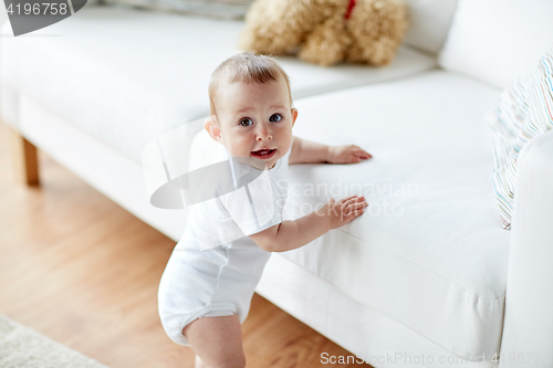 Image of happy little baby boy or girl at home