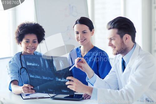 Image of group of happy doctors discussing x-ray image