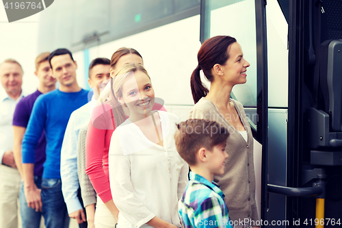 Image of group of happy passengers boarding travel bus