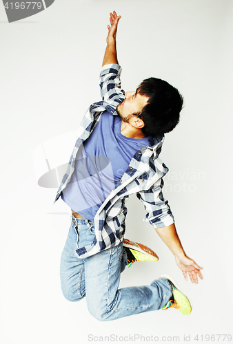 Image of young pretty asian man jumping cheerful against white background