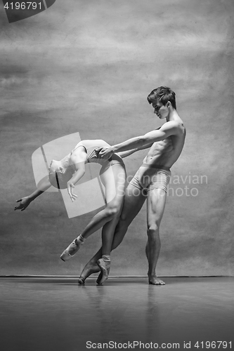 Image of Couple of ballet dancers posing over gray background