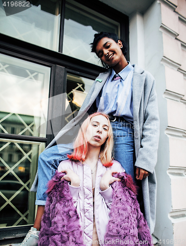 Image of Two teenage girls infront of university building smiling, having fun traveling europe, lifestyle people concept 