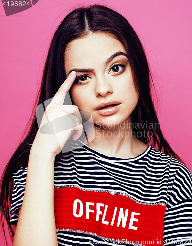 Image of young pretty teenage woman emotional posing on pink background, fashion lifestyle people concept 