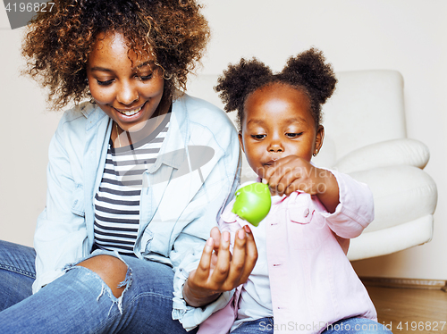 Image of adorable sweet young afro-american mother with cute little daughter, hanging at home, having fun playing smiling, lifestyle people concept, happy smiling modern family 