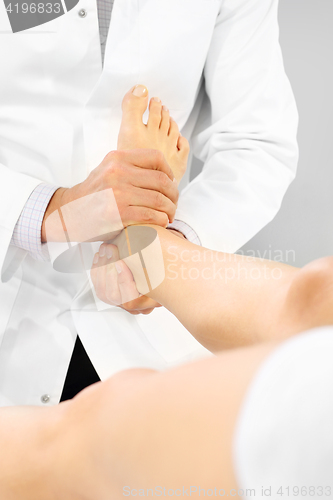 Image of Orthopedic surgeon examines the patient&#39;s foot