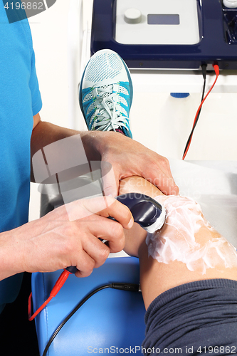 Image of Physiotherapy, ultrasound Physiotherapist doctor performs surgery on a patient&#39;s leg