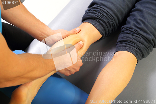 Image of Masseur massaged his calf.