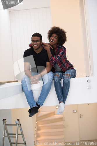Image of couple having break during moving to new house