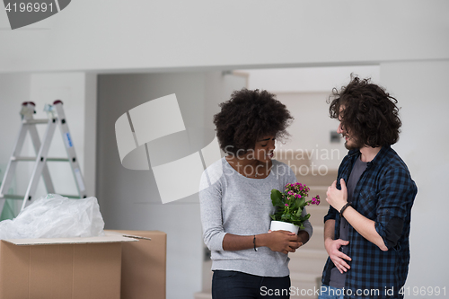 Image of multiethnic couple moving into a new home