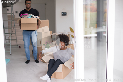 Image of African American couple  playing with packing material