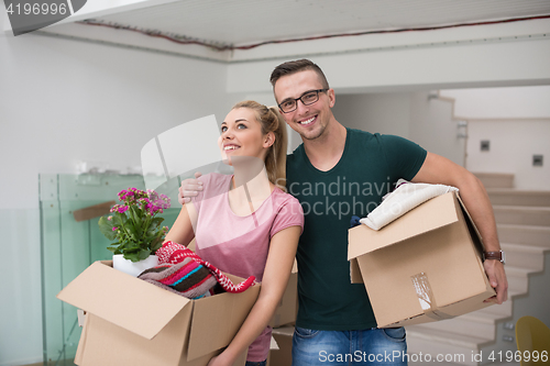 Image of young couple moving into a new home