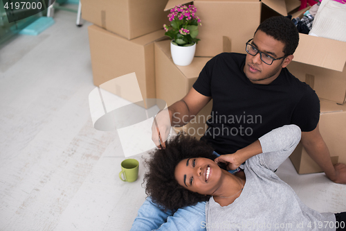 Image of African American couple relaxing in new house