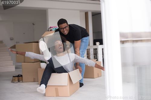 Image of African American couple  playing with packing material