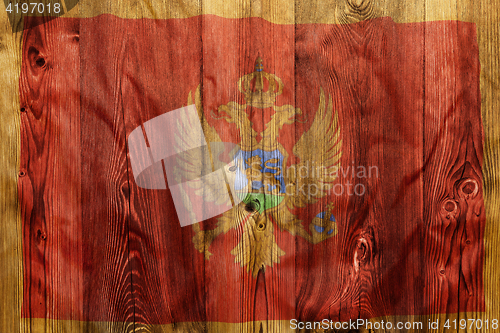 Image of National flag of Montenegro, wooden background
