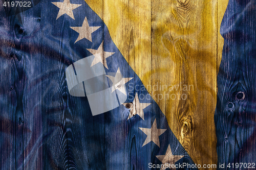 Image of National flag of Bosnia and herzegovina, wooden background