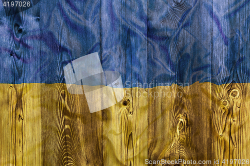 Image of National flag of Ukraine, wooden background