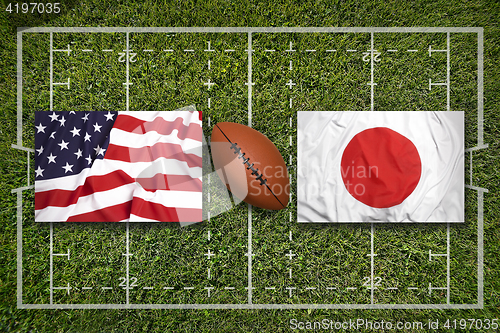 Image of USA vs. Japan flags on rugby field