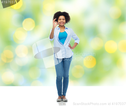 Image of happy african american woman showing ok hand sign