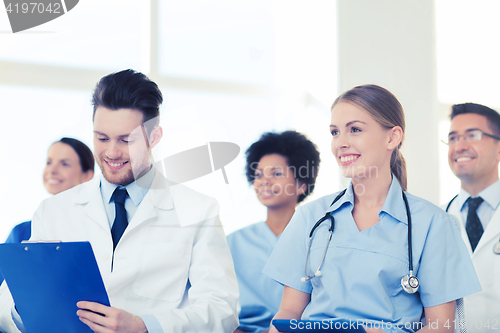 Image of group of happy doctors on seminar at hospital