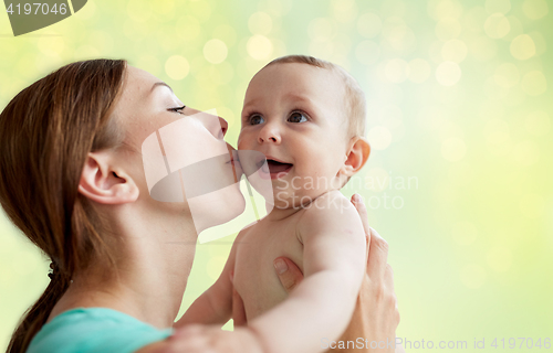 Image of happy young mother kissing little baby