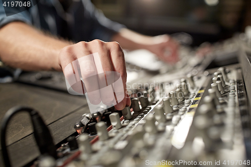 Image of man using mixing console in music recording studio