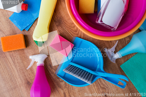 Image of basin with cleaning stuff on wooden floor