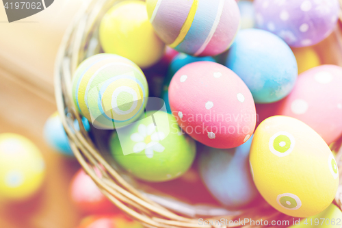 Image of close up of colored easter eggs in basket