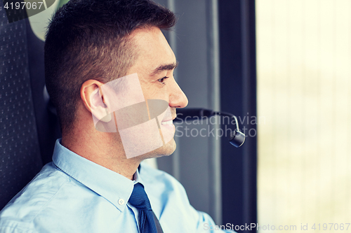 Image of happy bus driver face with microphone