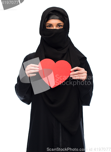 Image of muslim woman in hijab holding red heart