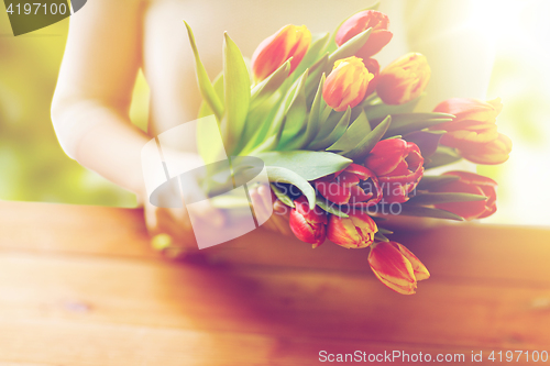 Image of close up of woman holding tulip flowers