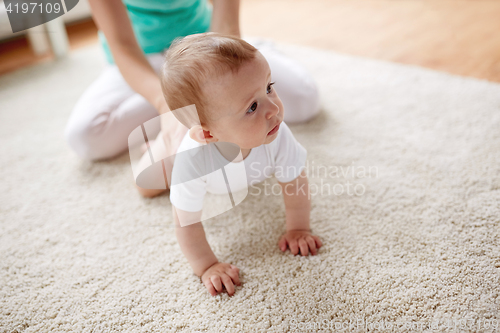 Image of mother with baby on floor at home