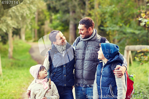 Image of happy family with backpacks hiking